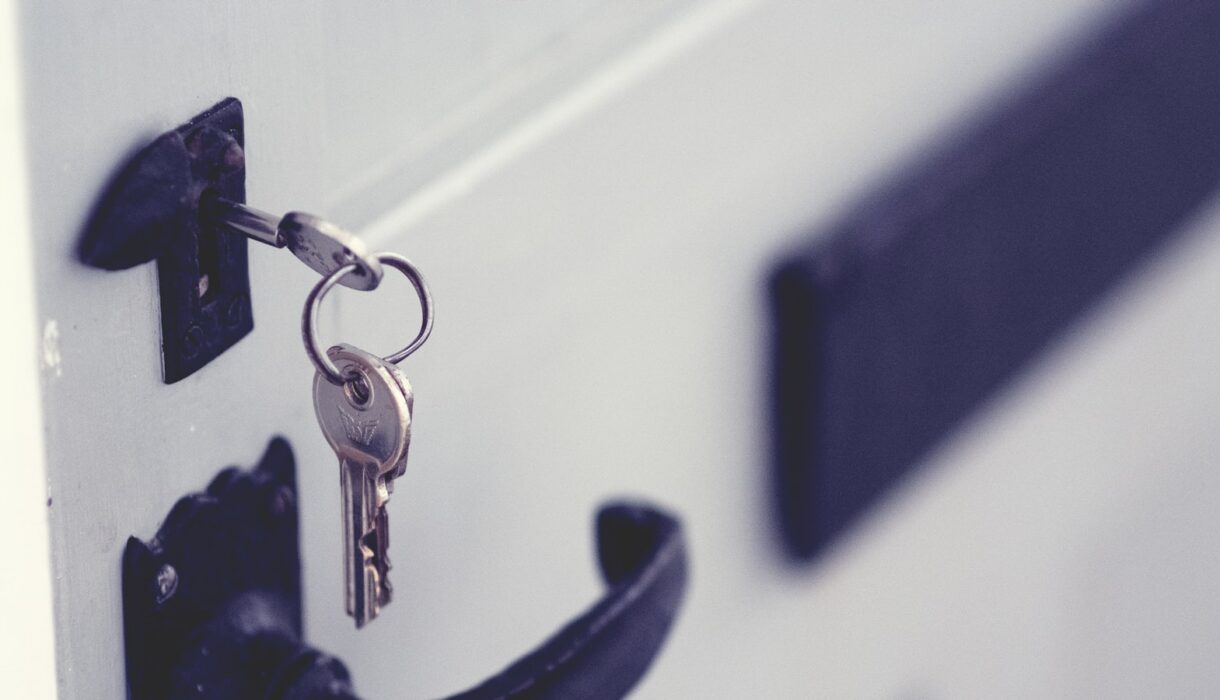 A black and silver padlock on a white door