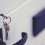 A black and silver padlock on a white door