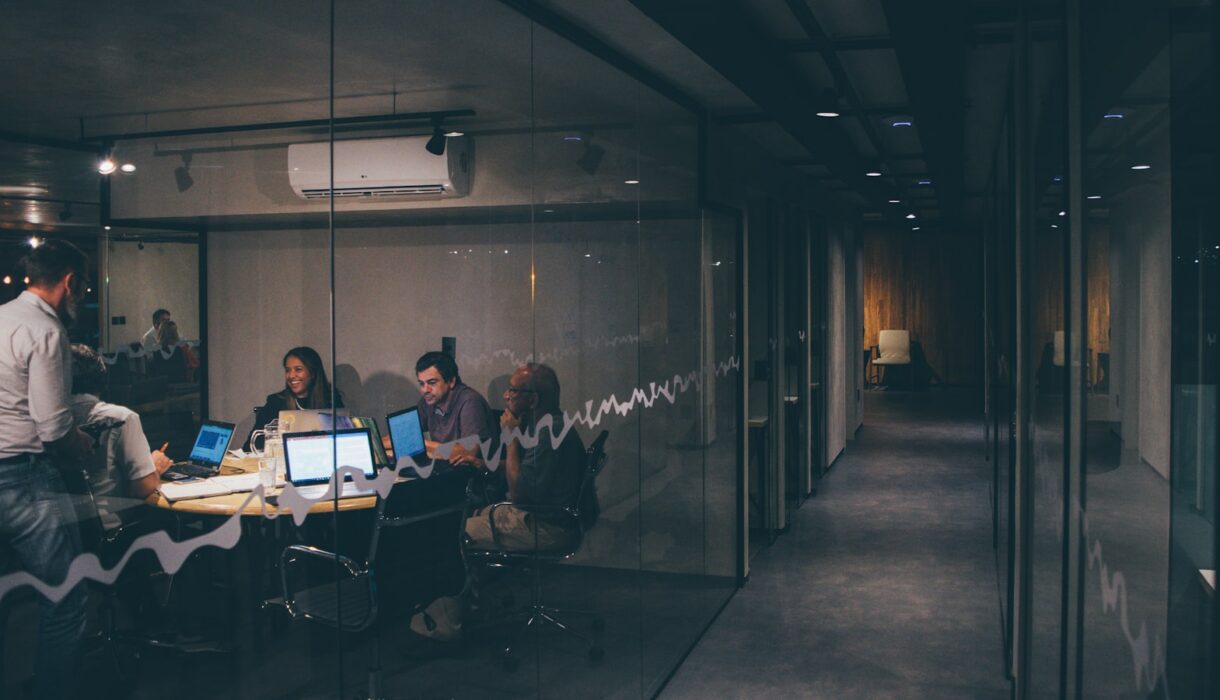 A group of people in a meeting around a table