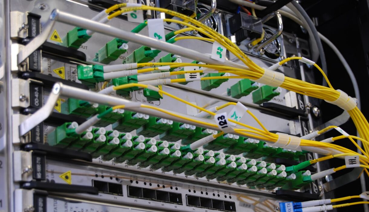 Fibre optic cables connected to a network switch in a server rack