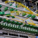 Fibre optic cables connected to a network switch in a server rack