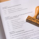 A wooden rubber stamp resting on an open legal document