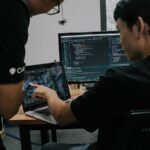 Two engineers working at computers in an office