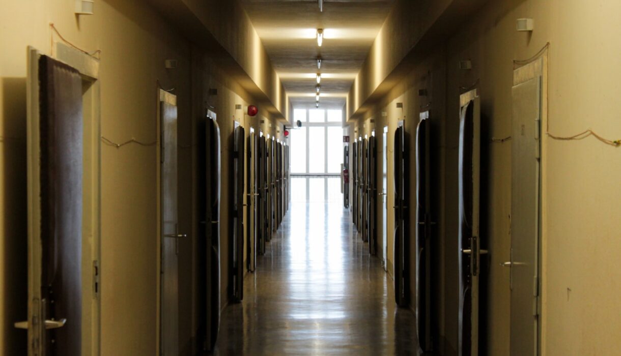 A long hallway lined with several closed doors