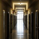A long hallway lined with several closed doors